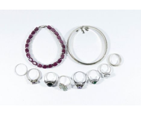 Silver jewellery to include hinged bangle, ruby line bracelet and eight silver dress rings 