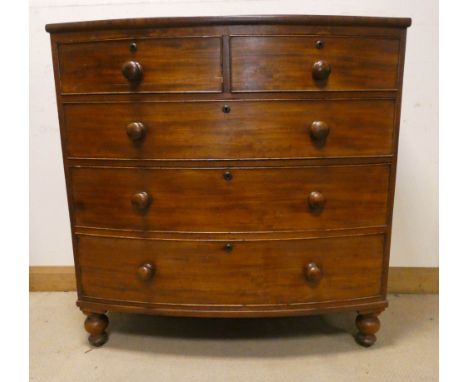 A mahogany bow front chest of three long and two short drawers with bun handles standing on turned feet, 3'6 wide 