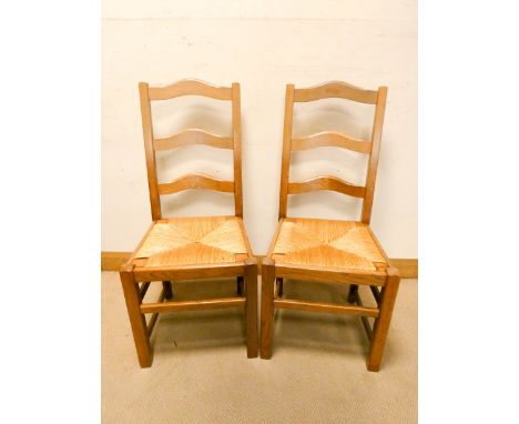 A set of six French style light oak ladder back dining chairs with rushed seats 