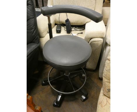 A vintage dentists or hairdressers adjustable chair 