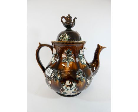 A Victorian barge ware teapot typically decorated with applied flowers and teapot finial, overall height to top of finial 30c