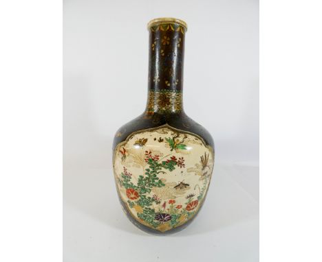 A Kinkozan Satsuma flask with detachable lid decorated with a panel of flowers and insects, signed on the base, height 26cms 