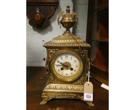 A French striking mantel clock by Japy Freres in decorative brass case with urn shaped finial