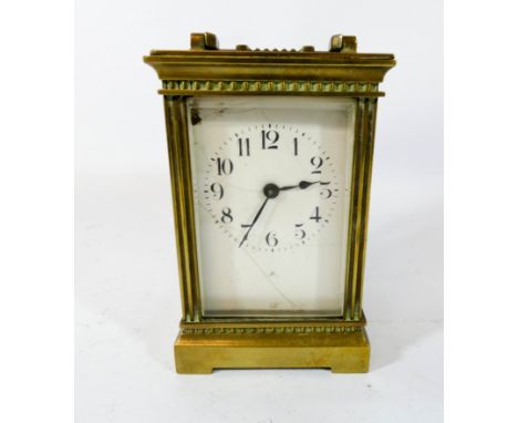 A gilt brass carriage clock with key 16cms with handle up   Enamel cracked 
