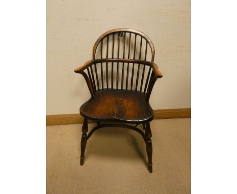 An oak Windsor stick back hooped elbow chair on Crinoline style base 