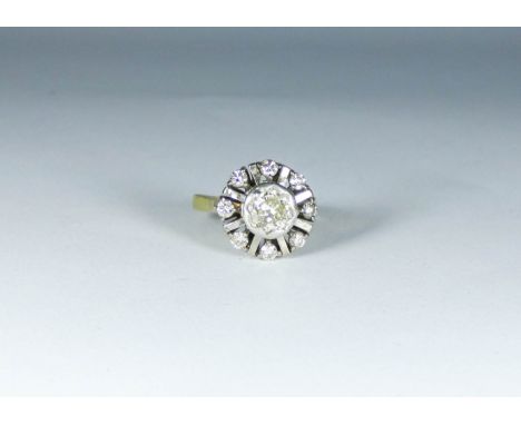 Diamond cluster ring set in a raised circular design on an 18ct yellow gold shank, ring size M