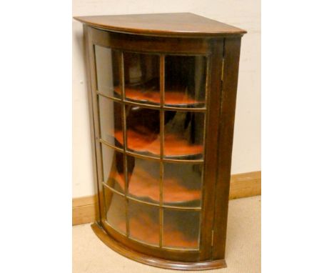 An Edwardian mahogany glazed bow front corner wall hanging cabinet 