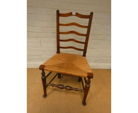 An antique oak ladder back dining chair with rush seat 