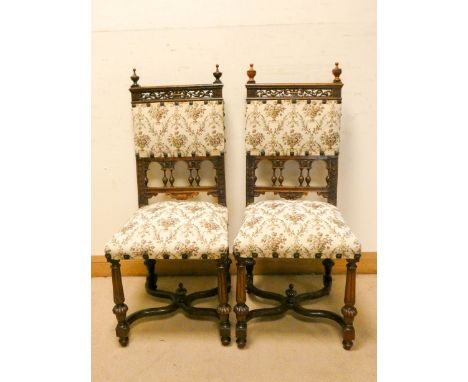A pair of late Victorian carved oak hall chairs with tapestry upholstered seats and back panels 