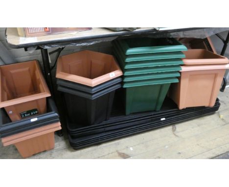 A large collection of square hexagonal plastic plant pots, some trough plant pots and a quantity of tray pots 
