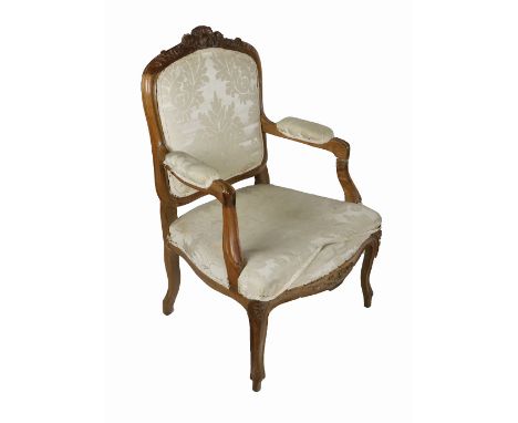 A 19th Century French carved fruitwood Fauteuil,&nbsp;the shield back with carved top issuing scroll arms covered in cream da