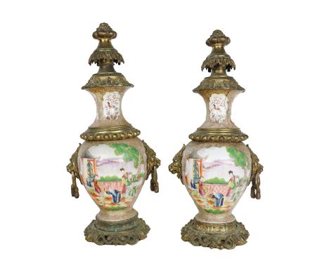 A pair of unusual Chinese porcelain and ormolu mounted Vases or Urns, each decorated with figures on a balcony by a lake and 