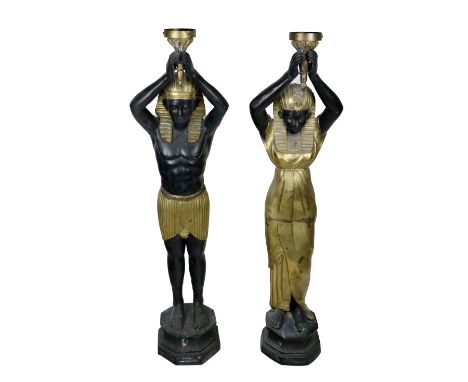 A pair of large bronze and gilt bronze Floor Lights, in the form of Ancient Egyptian women, each holding a light fitting&nbsp