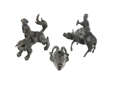 An antique Chinese Lion, with removable grotesque faced figure, a bronze Buffalo with removable driver mounted, and a fine sm