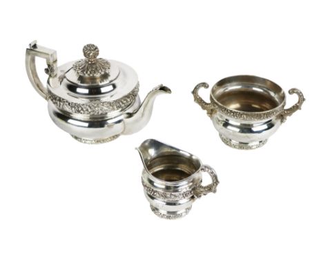 A fine quality and heavy 19th Century three piece English silver Tea Service, the teapot with hinged lid surmounted with pome