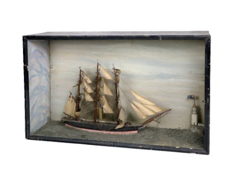 An attractive cased Model, of a five mast Sailing Ship on calm seas with light house. (1)