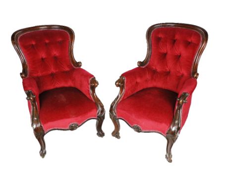 A pair of Irish Victorian mahogany framed Armchairs, covered in deep button back red fabric on front carved cabriole legs on 