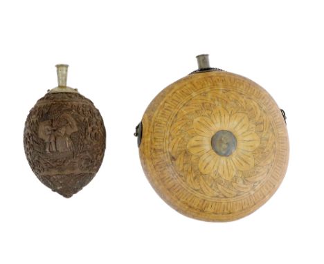 An early 18th Century Dutch carved coconut Powder Flask, decorated with overall floral design, figural panels, and lion mask 