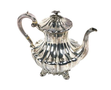 A large Victorian silver Teapot, by John Welby, London, 1838, the hinged lid with floral capital, scroll handle and spout, on