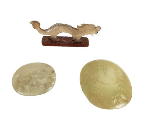 A 19th Century oval shaped Chinese Jade Panel, decorated with central pomegranate and flower surround, approx. 8.5 cms (3 1/2