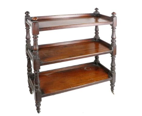 An Irish 19th Century mahogany framed three tier Dumbwaiter, with turned finials and pillar supports on brass and porcelain c