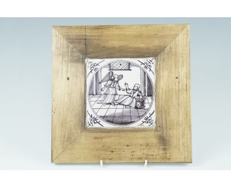 A Delft tile depicting the Annunciation, circa 17th Century, mounted in later pine frame, 13 cm x 13 cm tile size