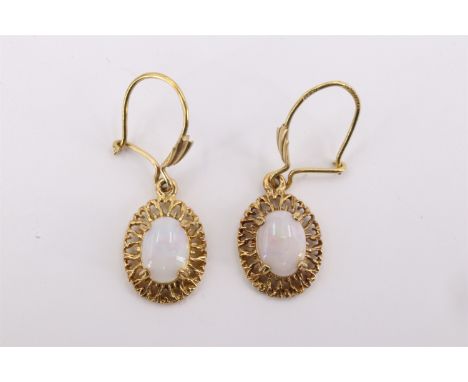 A pair of 9 ct gold and opal pendant earrings, having a 7 x 5 mm opal cabochon claw set within a naturalistic openwork frame,