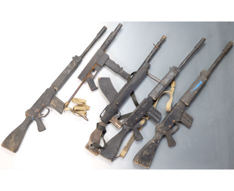 A group of mid-20th Century wooden mock automatic rifle and submachine guns, ex British Army training ranges, Otterburn