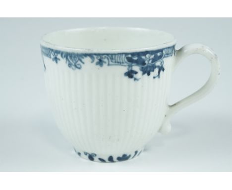 An 18th Century Worcester teacup, having reeded sides and underglaze blue rim and foot, crescent mark to base, 6.5 x 6 cm exc