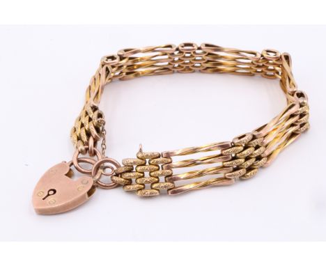 An early 20th Century 9 ct yellow metal gate-link bracelet, of alternately textured and twisted links, 13.2 g