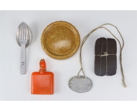A German Third Reich army field dressing, an identity disc, fat dish, cutlery combination and gas decontamination agent bottl