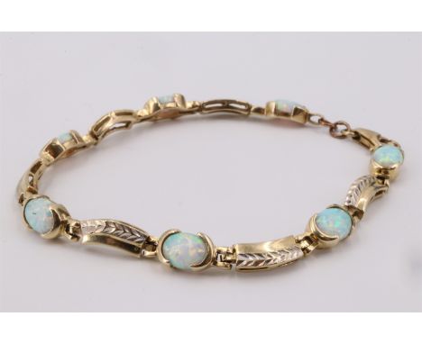 A contemporary faux opal and 9 ct yellow metal bracelet, comprising seven oval opal cabochons each of approx 8 mm x 6 mm, cli