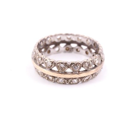 A vintage 9 ct yellow metal and white stone eternity ring, having a central band between adorsed bands of stone set heart sha