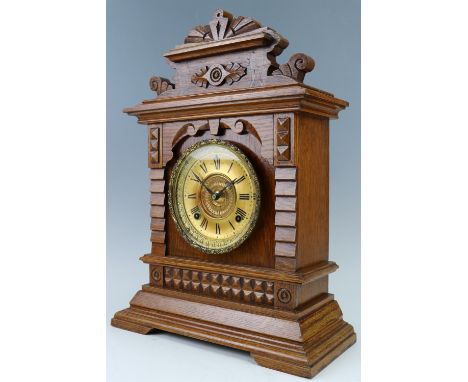 A late 19th Century Ansonia oak mantle clock, having a two train movement striking on a gong, 32 cm x 14 cm x 45 cm 
