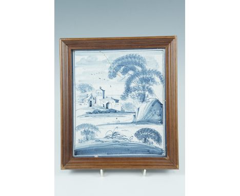 A framed Delft blue and white tile, 24.5 x 22 cm overall 