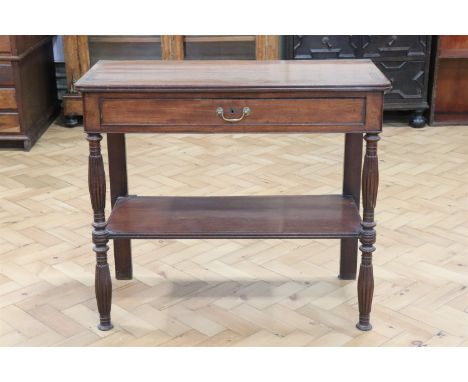 An early 19th Century mahogany side table, having a frieze drawer with brass bale handle, stretcher shelf and reeded legs, (m