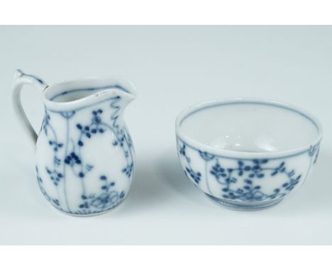 A 19th Century diminutive jug and sugar basin, having blue and white lace underglaze decoration, the bases having underglaze 