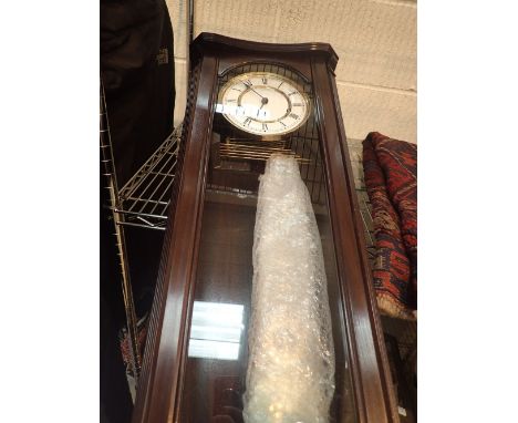 Hermle dark mahogany Westminster chime wall clock, complete with key and pendulum CONDITION REPORT: This item is working at l