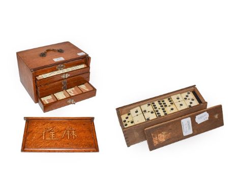 An oak cased Chinese mahjong set and a box of ebony and bone dominoes .  Composite tiles. 