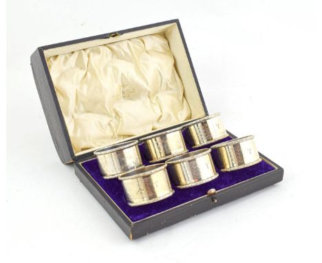 A Cased Set of Six Napkin Rings Four by Henry Matthews, Birmingam, 1918 and 1919, one by Walker and Hall, Birmingham, 1919 an