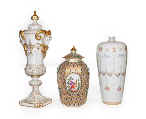 Continental porcelain comprising a slender covered vase with twin ring and goats mask handles, decorated with a vignette port