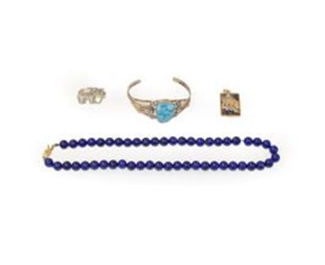 A lapis lazuli bead necklace, clasp stamped '14',length 43cm; a 9 carat gold agate pendant; a bangle stamped 'STERLING'; and 