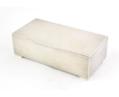 A George VI Silver Cigarette-Box, by Padgett and Braham Ltd., London, 1938, oblong, the sides and flat hinged cover overall e