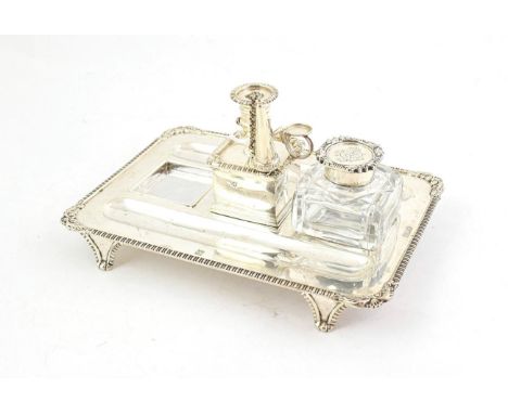 A Victorian Silver Inkstand, by Charles Stuart Harris, London, 1899, oblong and on gadrooned tapering panel feet, with gadroo