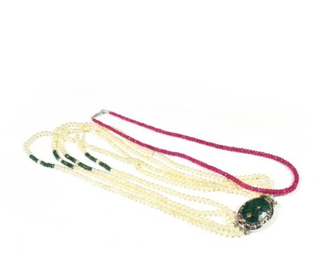 A ruby bead necklace, length 47.5cm; and a cultured pearl four row necklace with an emerald clasp, length (of shortest strand