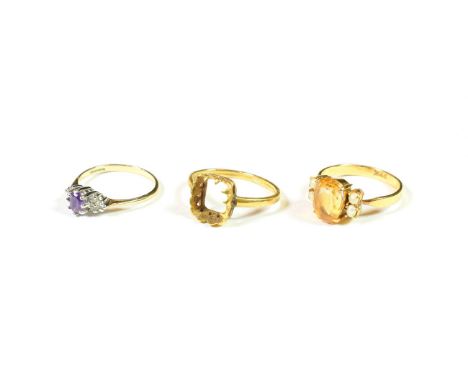 A 9 carat gold amethyst and diamond ring, finger size N; a citrine and seed pearl ring, stamped '22K', finger size O; and a v