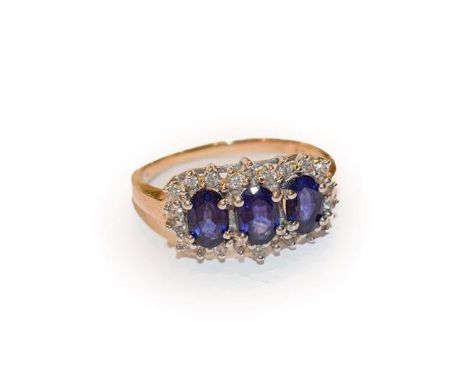 A 9 carat gold sapphire and diamond cluster ring, three oval sapphires within a border of eight-cut diamonds, in white claw s