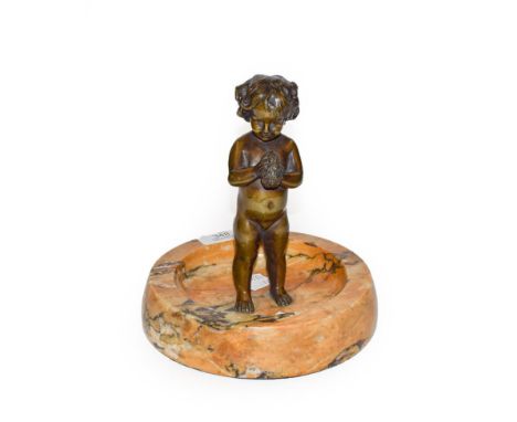 Early 20th century bronze of a child with sponge on an onyx dish base, 18cm diameter, 20cm high 