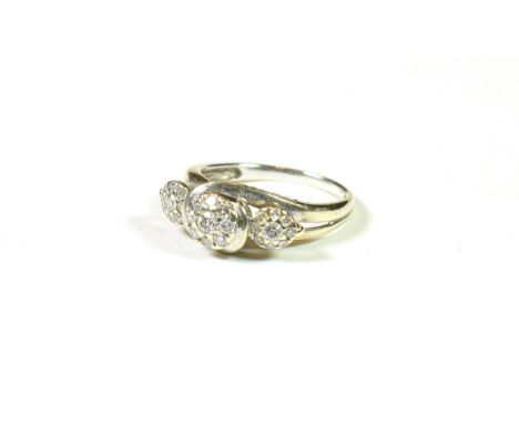 A 9 carat white gold triple diamond cluster ring, finger size K1/2.  The ring is in good condition. It is hallmarked with spo