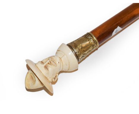 An ivory mounted malacca walking cane, early 20th century, the handle carved as a bust, possibly ''Baden Powell'', stamped fe